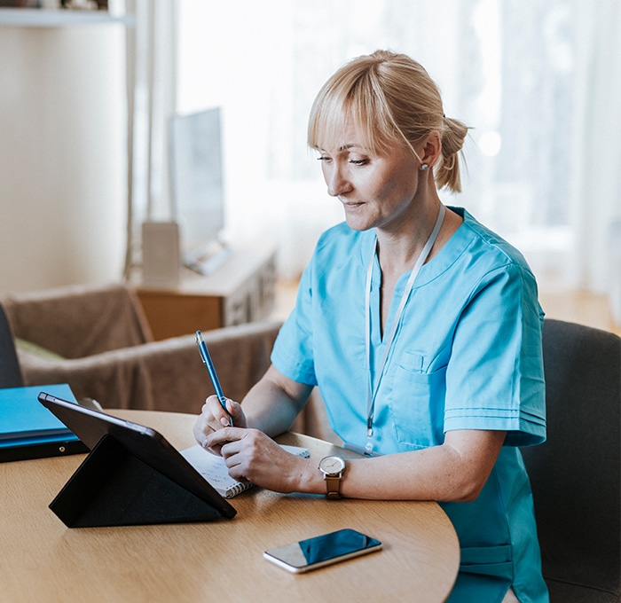 nurse looking at tablet