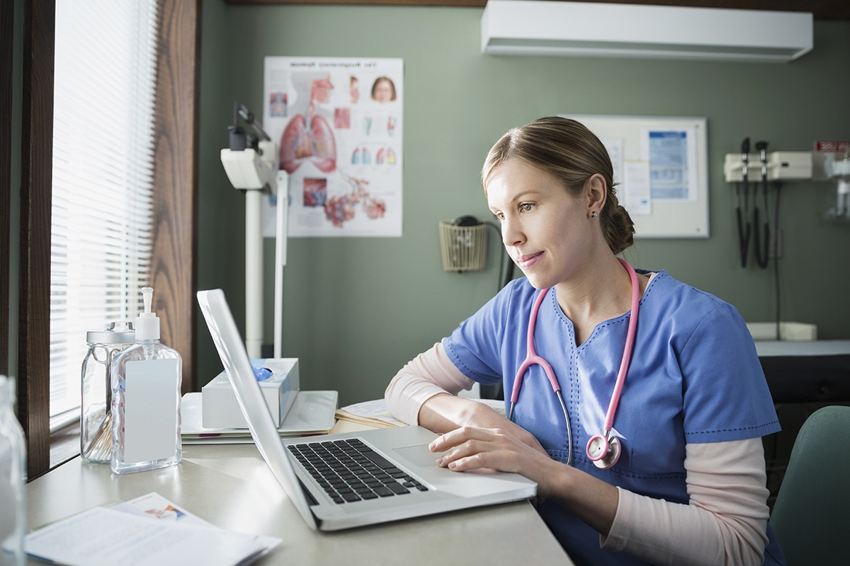 nurse looking at computer