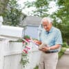 Man at mailbox wearing HomeSafe pendant
